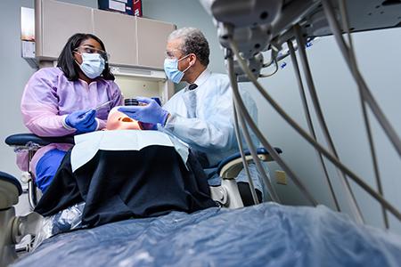 Remington College Students receive guidance from Instructors in the Dental Assisting Program